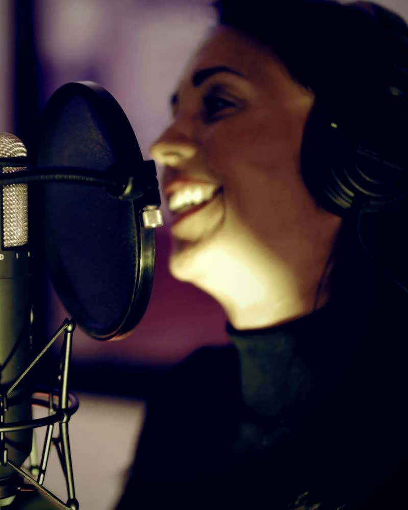 Elimar Ugueto laughing at the microphone in her studio
